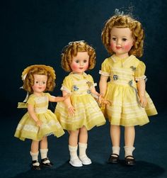 three dolls are standing next to each other