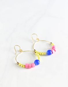 Jazz up your work attire with the colors of the tropics with these colorful, beaded earrings!  Dangling from a tarnish-free, gold-plated hoop, the terracotta, brass, and glass beads add a pop of color to your simple t-shirt or work outfit! OVERVIEW ❤︎ 1.5 inches in diameter ❤︎ Allow for 3 days for your item to be made ❤︎ This pair of fun, dangly earrings is perfect to gift your sister, mother, best friend ❤︎ Ready to be gifted, comes carefully gift-wrapped ❤︎ See all images on the listing ❤︎ All handmade by Amy Nieto of Little Bright Studio in Las Vegas, Nevada ☞ Contact me if you have any questions! https://www.etsy.com/conversations/new?with_id=11657624&referring_id=6090343&referring_type=shop&recipient_id=11657624 MEASUREMENTS & MATERIALS ￮ 1.5 inches long ￮ Gold-plated, tarnish-free wi Yellow Bohemian Hoop Earrings For Beach, Bohemian Yellow Hoop Earrings For Beach, Trendy Tiny Beads Earrings For Summer, Summer Everyday Dangle Hoop Earrings, Yellow Hoop Earrings For Summer Gift, Yellow Hoop Earrings As A Summer Gift, Yellow Hoop Earrings As Summer Gift, Summer Yellow Hoop Earrings As Gift, Colorful Beads Hoop Earrings For Beach