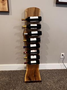 a wooden wine rack with several bottles on it