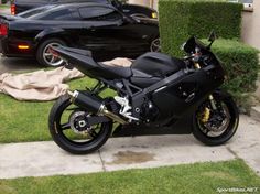 a black motorcycle parked in front of a house