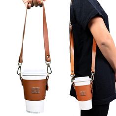 a person holding a coffee cup in one hand and a leather shoulder bag on the other