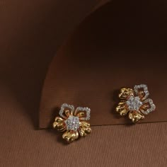 Description Take a bit of beautiful imagery with you wherever you go with this cute pair of stud earrings by Tarinika. They are modeled after the distinctive silhouette of Hibiscus, embellished by high quality CZ stones. A great way to show love for flowers in your everyday look, and a charming gift giving idea for valentines day. Details & Specifications: Materials used: CZ Stone with Antique and White Gold Plating Weight - Earrings 5 gm Length - Earrings 1.5 cm Make it custom Want to make it a Luxury Gold Earrings With Tilla, Stud Diamond Earrings Design, Gold Studs Designs, Flower-shaped Cubic Zirconia Earrings, White Stone Studs Earrings Gold, Cubic Zirconia Flower-shaped Earrings, Flower Shaped Earrings With Diamond Accents, Flower Shaped Cubic Zirconia Diamond Earrings Gift, Flower Shaped Diamond Accent Earrings For Gifts