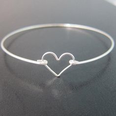 Sterling Silver Heart Bangle Bracelet - A sterling silver heart charm has been transformed into a dainty & delicate heart bracelet with a sterling silver bangle band for you to wear or gift. This is the perfectly dainty heart bracelet for a Valentine's Day gift. Or if you need bridesmaid wedding jewelry and have been looking for sterling silver heart bracelets for bridesmaids, these make for cute bridesmaid gift bracelets. This sterling silver heart jewelry looks great together with others f Minimalist Sterling Silver Heart Bracelet For Mother's Day, Silver Heart Bracelet For Wedding On Valentine's Day, Silver Minimalist Heart Bracelet For Valentine's Day, Dainty Silver Bracelets For Valentine's Day, Minimalist Silver Heart Bracelet For Valentine's Day, Silver Dainty Bracelet For Valentine's Day, Minimalist Bangle Jewelry For Valentine's Day, Dainty Silver Bracelet For Valentine's Day, Minimalist Heart Bangle Bracelet As Gift