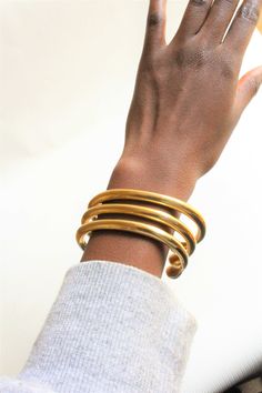 Handcrafted in Nairobi, Kenya. A beautiful,unique brass cuff that is a must have for all! A perfect everyday, minimal bracelet that you should have! Adjustable and easy to wear. Simple but elegant! Perfect gift for a loved one. **This listing and price is for one cuff only SHIPPING Express shipping (via DHL) takes 2-4 WORKING DAYS to be delivered to you. Gold Adjustable Cuff Bracelet, Adjustable Gold Cuff Bangle, Gold Brass Cuff Bracelet, Unique Gold Metal Cuff Bracelet, Adjustable Gold Brass Cuff Bracelet, Adjustable Brass Cuff Bracelet, Adjustable Gold-tone Cuff Bracelet Bangle, Traditional Handmade Brass Cuff Bracelet, Unique Brass Cuff Bracelet