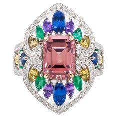 Introducing the Summer Radiance Ring capturing this season's vibrancy and joy. At its heart lies an emerald cut natural pink tourmaline encircled with a blend of colorful sapphires, emeralds and diamonds set in 18k white gold. This unique design is the signature style of Zahira and together with the selection of gems this ring creates a spectrum of color that is sure to be a conversation starter. Pink Tourmaline - 2.78ct Blue Sapphire - .78ct Purple Sapphire - .36ct Yellow Sapphire - .53ct Emera Columbian Emeralds, Yellow Gold Cocktail Ring, Thai Art, Gold Cocktail, Purple Sapphire, Jewels Rings, Gold Cocktail Ring, Diamond Cocktail Rings, Sapphire Stone