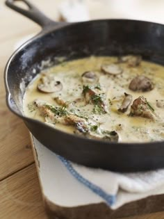 a pan filled with food sitting on top of a wooden table