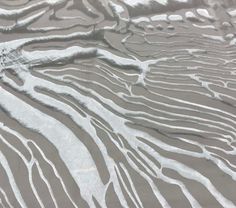 the sand is covered with white stuff and has lines drawn on it in different directions