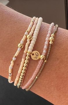 Includes 14k gold plated beads that will not tarnish. This stack also has 24k plated gold, matte cream, iridescent milky cloud, translucent pink and quartz colored beads. Made with love, XO. Stretch Bracelets Ideas, Neutral Bracelets, Quartz Colors, Stackable Bracelets, Beaded Stretch Bracelet, Bracelet Stack, Stretch Bracelet, Gold Beads, Jewelry Ideas