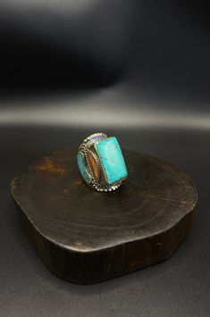 vintage handcrafted Tibetan Nepalese ring with turquoise and coral stone Turquoise Multi-stone Ring For Gift, Artisan Multi-stone Turquoise Ring, Handmade Turquoise Rectangular Rings, Adjustable Traditional Turquoise Ring, Unique Turquoise Ring With Natural Stones, Bohemian Turquoise Multi-stone Rings, Handmade Multicolor Artisan Turquoise Ring, Handmade Artisan Multicolor Turquoise Ring, Unique Rectangular Turquoise Ring