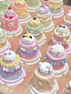 there are many hello kitty cakes on the table