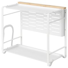 a white shelf with a wooden top and handles on the bottom, against a white background