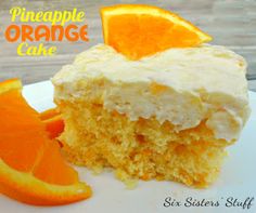 an orange cake with cream frosting and sliced oranges on a white plate next to the words, pineapple orange cake six sisters stuff