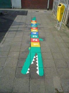 an airplane painted on the sidewalk with numbers and arrows pointing in different directions to each other