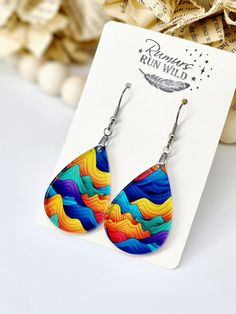 Colorful Mountain Earrings.  Lightweight Teardrop Earrings made from a printed acrylic. Each pair will vary a small amount as they are laser cut from a larger sheet of acrylic.  With the clear acrylic on top and the print on the back, you get a wonderful shine that makes it pop. Similar look to having resin poured on top of the image.    Pendant measures 1.5 inches long and 2.5 inches long with hardware. So a perfect length for most.  Made with stainless steel pinch bail hardware, so they will be hypoallergenic and stay front facing. Super Lightweight!  Features:  ⭐️Lightweight  ⭐️Front Facing ⭐️Waterproof  ⭐️UV printed for long lasting ⭐️Statement Jewelry Colorful Dangle Earrings For Gift, Colorful Earrings As A Gift, Rainbow Colorful Earrings For Gift, Colorful Drop Earrings For Gift, Multicolor Teardrop Drop Earrings With Ear Wire, Multicolor Hypoallergenic Teardrop Earrings, Hypoallergenic Multicolor Teardrop Earrings, Artistic Multicolor Hypoallergenic Jewelry, Multicolor Dangle Teardrop Earrings As Gift