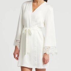 Anthropologie Rya Collection Rosey Cover Up In Ivory Satin. Short Style Robe With Side Pockets. Ties At Waist. Lace Trimmed Sleeves. New With Tag. Underarm To Underarm Measured Flat Across The Back Is 20" And Stretches To 22". Hip To Hip Measured Flat Across The Back Is 24" And Stretches To 26". Length Is 34" Measuring From Neckline To Hem At The Back. 100% Polyester. Smoke Free, Pet Free Home. Chic V-neck Sleepwear For Wedding Night, Elegant Long Sleeve Lace Sleepwear, Elegant White Sleepwear With Delicate Lace, Cream Elegant Sleep Dress, Cream Sleepwear For Spring, Elegant Long Sleeve Cream Sleepwear, Elegant Spring Sleepwear With Lace Trim, Elegant Fitted Cream Sleepwear, Elegant Lace Sleepwear For Spring