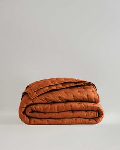 an orange blanket folded on top of each other