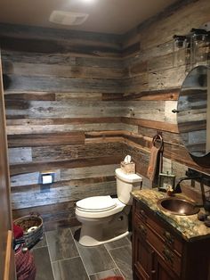 a bathroom with wooden walls and tile flooring