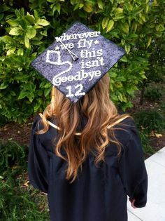 a person wearing a graduation cap with writing on it