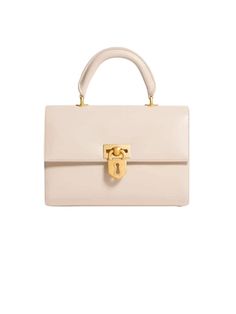 a white handbag with a gold lock on the handle