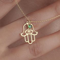 Birthstone Hamsa necklace Product Description: Discover the enchanting elegance of our Birthstone Hamsa necklace, a stunning blend of spiritual symbolism and personalized style. This exquisite necklace features a beautifully designed Hamsa hand, adorned with a vibrant birthstone that adds a unique touch to this timeless piece. Crafted with care, this gold or silver Hamsa necklace is perfect for women of all ages. Whether you're looking for a thoughtful gift for Mother's Day, a unique bridesmaid necklace, or a special treat for yourself, this necklace makes a meaningful statement. The Hamsa hand is known to provide protection and bring good fortune, making it an ideal charm for everyday wear. Celebrate your loved ones with this dainty Hamsa necklace, which beautifully combines tradition wit Spiritual Gemstone Jewelry Gift, Spiritual Gemstone Jewelry As A Gift, Gold Spiritual Crystal Necklace With Birthstone, Gold Birthstone Crystal Necklace For Spiritual Healing, Gold Crystal Birthstone Necklace For Spiritual Healing, Spiritual Good Luck Necklace With Round Shape, Good Luck Spiritual Necklace With Round Shape, Spiritual Round Good Luck Necklaces, Spiritual Good Luck Round Necklace