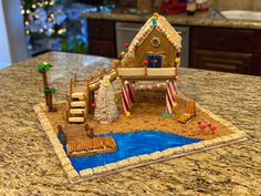 a gingerbread house on top of a kitchen counter