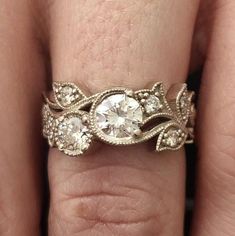 a close up of a person's hand with a wedding ring on their finger