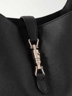 Gucci's 'Jackie' bag is one of the house’s most recognisable designs. This version has been crafted in Italy from full-grain leather and fitted with a logo-engraved piston clasp across the open top. It has an adjustable shoulder strap and can carry noise-cancelling headphones, keys and a paperback. Luxury Leather Hobo Bag With Leather Handles, Luxury Bucket Satchel For Business, Gucci Satchel Shoulder Bag In Textured Leather, Classic Gucci Bag With Detachable Strap, Gucci Shoulder Bag With Leather Lining For Travel, Gucci Business Crossbody Satchel, Gucci Shoulder Satchel For Everyday Use, Designer Leather Hobo Bag With Metal Hardware, Classic Gucci Satchel For Business