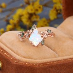 a white opal ring sitting on top of a box