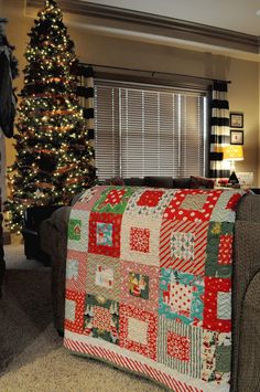 a living room filled with furniture and a christmas tree