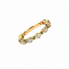 a gold ring with green and white stones