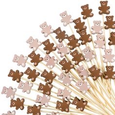 a bunch of brown and white teddy bears on toothpicks