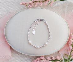 Personalized precious sterling silver bracelet with gorgeous soft white freshwater rice pearls. This is a dainty timeless keepsake gift for infants, toddlers, kids, and little girls! Bracelet comes in beautiful gift box.  Each bracelet has a grow-with-me extension chain so it can be adjusted for a perfect fit. Please see sizing chart in listing for help with determining the correct size.   Made in the USA PERSONALIZE IT!  Make it extra special by adding an initial charm so it's unique just for h Adjustable Sterling Silver Bracelet With Pearls For Gift, Silver Pearl Bracelet With Tiny Beads As Gift, Silver Pearl Bracelet For Gift, Silver Pearl Bracelet With Tiny Beads For Gift, Elegant Beaded Jewelry For Baptism, Silver Beaded Jewelry For Baptism, Adjustable Sterling Silver Pearl Bracelet For Gift, Personalized Silver Dainty Pearl Bracelet, Elegant Silver Beaded Bracelets For First Communion