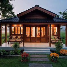 a small wooden house sitting on top of a lush green field