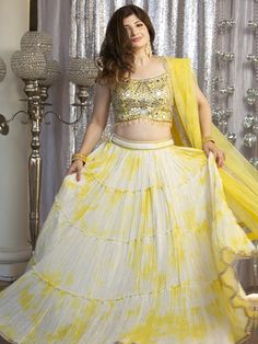 Go all out in this whimsical lehenga, studded with precious mirror, pearl, stone, embroidery work, which is sure to bring out the innate grace and grandeur in you! Color - Lemon Yellow Fabric & Work Style - - Silk blouse: mirror, pearl, stone, embroidery work. - Soft net lehenga: mirror, pearl, stone, embroidery work. - Soft net dupatta: embroidery work. Details - - Assured quality - Wash care instruction: Dry clean only. - Slight variation in color is possible due to digital photography. Festive Saree Set With Stone Work, Anarkali Sets With Stone Work For Diwali, White Bollywood Style Hand Embellished Dupatta, White Lehenga With Pearl Embroidery For Diwali, Traditional Drape Sharara With Stone Work For Festivals, Diwali Anarkali Sets With Stone Work, Traditional Sharara With Stone Work For Festivals, Festival Sharara With Stone Work, Festival Traditional Drape Sharara With Stone Work