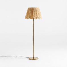 the floor lamp is made out of wood and has a large shade on it's base