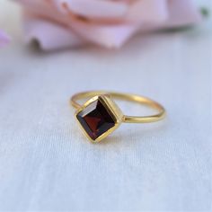 D E T A I L S - Stone: Natural Garnet Stone Shape: Cushion - Square Material: Sterling silver The fit: True to US ring size Finish: Smooth and Gold Plated to a high shine S H I P P I N G & P R O D U C T I O N - My current production time is 2-6 business days, which means after those days are up, your order ships! I make everything custom to order, by hand, but I promise you it's worth the wait! R U S H - M Y - O R D E R - If you're in a rush to get your pretty new pieces, please send me a me Garnet Open Ring For Anniversary, Garnet Solitaire Ring As Gift, Elegant Garnet Stackable Rings For Anniversary, Elegant Stackable Garnet Gemstone Rings, Elegant Garnet Gemstone Stackable Rings, Garnet Round Cut Rings As Gift, Garnet Round Cut Rings For Gift, Formal Sterling Silver Stackable Rings With Birthstone, Garnet Solitaire Jewelry As Gift