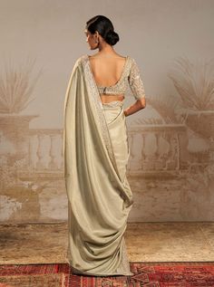 Step into sophistication with this silver green persian embroidered sari set – a perfect harmony of tradition and contemporary flair. This stunning ensemble features a pre-draped sari and drape blouse, intricately embroidered in silver green motifs. The striking color and persian-inspired design add a regal touch, making it an ideal choice for special occasions. Diwali Silver Pre-draped Saree With Mirror Work, Elegant Silver Saree With Mirror Work, Elegant Silver Pre-draped Saree With Mirror Work, Draped Saree For Wedding And Eid, Eid Wedding Draped Saree, Silver Blouse With Sheer Dupatta And Traditional Drape, Traditional Silver Blouse Piece With Sheer Dupatta, Elegant Draped Dupatta With Mirror Work, Silver Saree With Resham Embroidery For Eid