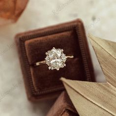 an engagement ring sits on top of a box