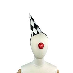 a white mannequin with a black and white checkered hat on it's head