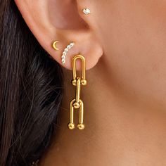 Ursula Hardware Earrings in Gold.  * 18K Gold plated. * Tarnish free.  * 1 Year Warranty. * Free Shipping STYLE TIP * A stunning hardware chain dangles elegantly on your ear, adding a touch of sophistication to your look. * Style with a cute top and knit pants for summer. Looks great stacked with dainty studs and slinky gold chains.  * Size: 40mm.  MATERIAL * 18K Gold plated. * Finely crafted in stainless steel CARE INSTRUCTIONS * Tarnish free. * Please remove hoops before shower, swim and exerc Tarnish Resistant Gold Plated Link Earrings, Tarnish-resistant Gold-plated Link Earrings, Gold-plated Link Earrings, Gold Plated Link Earrings, Yellow Gold Link Earrings For Everyday, Yellow Gold Link Earrings, Everyday Yellow Gold Link Earrings, Link Shaped Pierced Earrings As Gift, Pierced Link Earrings For Gift