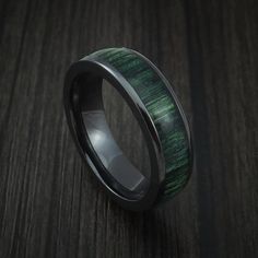 a wedding band with green wood inlay