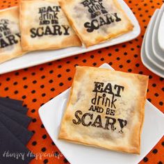 some crackers that have been decorated with words on them and are sitting on plates