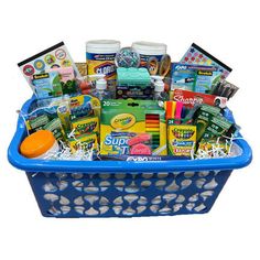 a blue basket filled with lots of different types of school supplies and condiments