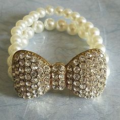 Never Used. Plastic Pearl. Gold Bow Tie Is Covered With Rhinestones. Elegant White Bracelet With Bling, White Bling Bracelets For Formal Occasions, Adjustable White Crystal Bracelet With Bling, Formal White Bling Bracelets, Bedazzled White Crystal Jewelry, White Crystal Bracelet With Rhinestones For Party, White Crystal Bracelet With Bling, Adjustable Bedazzled Formal Jewelry, White Party Bracelets With Rhinestones