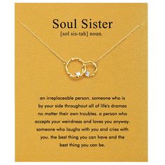 a gold necklace with two interlocked circles on it and an inscription that says soul sister