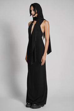 Make them take a second glance. Maxi dress made from luxuriously dense Jersey, featuring an add-on hood that can be draped across the shoulders and over the crown of the head, with plunging halter top neckline. FIT NOTES:Tatianna wears a size Small, 5'9, with a 26" waist.MATERIALS:95% rayon 5% spandexMade in China Black Dress With Hood, Black Stretch Hooded Top, Washed Black Cotton Hooded Top, Gothic Dress With Hood, Fitted Black Hooded Dress, Dress With A Hood, Top Neckline, Steel Grey, Halter Top