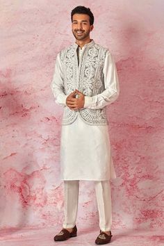 Grey open bundi with floral vintage pattern and contrast dori intricate embroidery. Paired with full sleeve kurta and pant style pyjama. - Aza Fashions Fitted Nehru Jacket With Chikankari Embroidery For Transitional Seasons, Eid Nehru Jacket With Embroidered Sleeves, Fitted Sleeveless Nehru Jacket With Intricate Embroidery, Traditional Festive Nehru Jacket With Embroidered Sleeves, Fitted Sleeveless Nehru Jacket With Resham Embroidery, Festive Fitted Nehru Jacket With Embroidered Sleeves, Fitted Sets With Embroidered Sleeves For Transitional Season, Embroidered Nehru Jacket For Eid Wedding, Designer Floral Embroidery Nehru Jacket