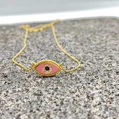 MELIGreece's lovely feminine chain necklace made of 18k yellow gold, a pink enamel eye with dotted surrounding, one central natural ruby weighting 0.01 cts. framed with natural diamonds weight in total : 0.03 cts. Dimensions of the eye charm : 1.7 cm. * 7.0 mm. / 0.67 - 0.27 inch. Length of the pink ruby diamond eye chain necklace : 39. 0 - 42. 0 cm. / 15.35 - 16.53 inch. A special gift proposal for this spring, accompanied by a stylish jewelry box and gift packaging. We combine it with MELIGreece's white diamond solid gold chain necklace https://www.etsy.com/listing/884490334/white-diamond-18k-yellow-or-rose-gold?click_key=d13d6ae24831f16551c74c1876b4d6af3387a9b5%3A884490334&click_sum=ceb56877&ref=shop_home_active_6&frs=1&sts=1. Important note: the enamel we use in our jewelry is of excel Pink Pendant Necklace With Adjustable Chain, Pink Pendant Charm Necklace With Delicate Chain, Pink Gold Plated Jewelry With Adjustable Chain, Pink Gold-plated Jewelry With Adjustable Chain, Handmade Yellow Gold Enamel Necklace, Yellow Gold Evil Eye Jewelry, Pink Gold Plated Round Necklace, Pink Gold Plated Necklace For Gift, Pink Gold-plated Necklace For Gift