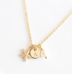 Personalized tiny Gold Starfish Necklace, Initial Necklace, 18K Gold Plated, Star fish charm necklace, Beach Jewelry pendant Mothers Day This elegant Necklace is a unique piece. Get a chance to have your Necklace engraved with your first name letter in the font of your choice. This is the perfect gift for Mothers Day, Grandmother, best friends, Bridesmaids...  Made with: - 26 inches or 66 cm 18K gold plated Chain - 18K gold-plated starfish 10 mm or .39 inches - 5 mm or .19 inches Fresh Water Pearl  - Personalized 18K gold plated disc 0.31 inches or  8 mm - Size: 26 inches or 66 cm - Can shorten it on demand. - It will come in a lovely jewelry box. This model is 100% handmade and is lead-free. You may also like Poodle Balloon Dog Gold Necklace https://www.etsy.com/listing/493535942/poodle-b Ocean-inspired Charm Necklaces As Gift, Ocean-inspired Charm Necklaces As Gifts, Ocean-inspired Charm Necklaces For Gifts, Ocean-inspired Charm Necklace For Gift, Starfish-shaped Necklace With Pearl Charm For Gift, Dainty Starfish Charm Jewelry For Gift, Dainty Starfish Charm Jewelry Gift, Gold Starfish Charm Necklace Gift, Starfish Charm Necklaces As Gift