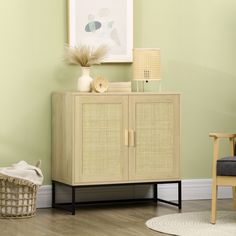 a living room with green walls and a wicker cabinet next to a gray chair